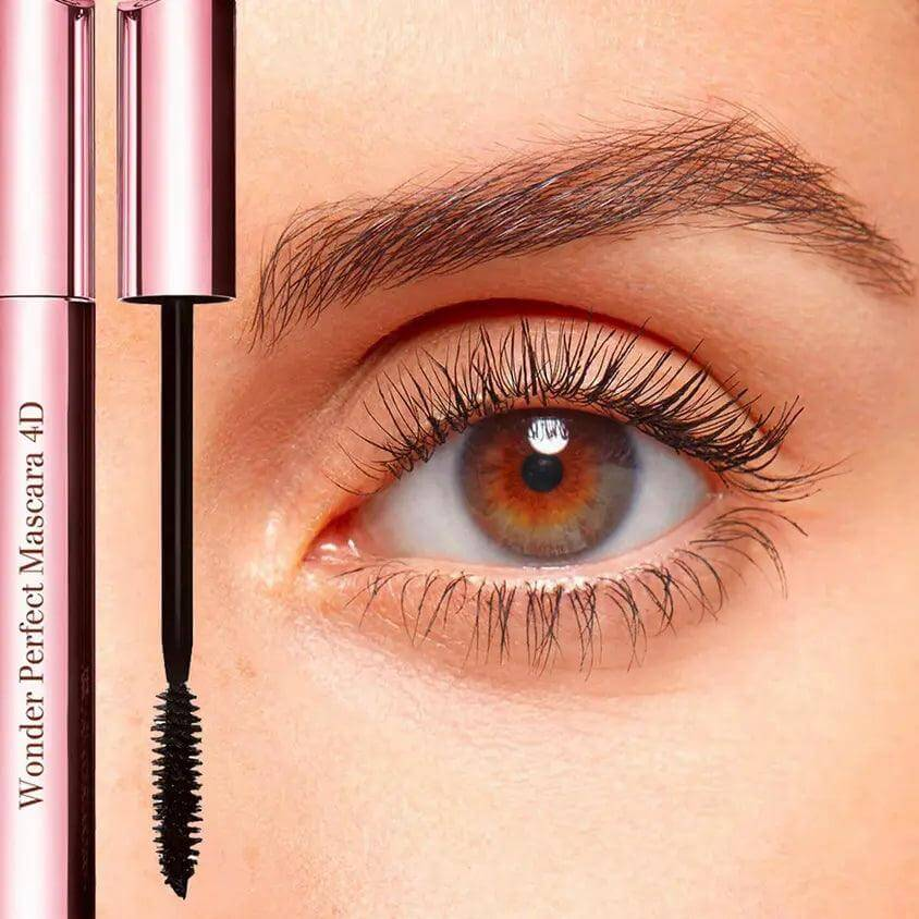 Woman's eye showcasing voluminous lashes enhanced by Clarins Wonder Perfect Mascara 4D, with product tube visible.