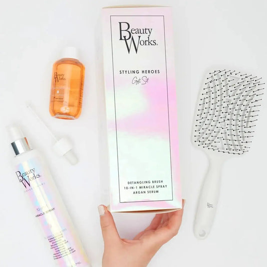 Beauty Works Styling Heroes Gift Set featuring detangling brush, 10-in-1 miracle spray, and argan serum for smooth, shiny hair.