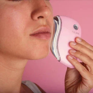 Woman using LUX SKIN® Face Sculpting Tool for facial contouring and rejuvenation.