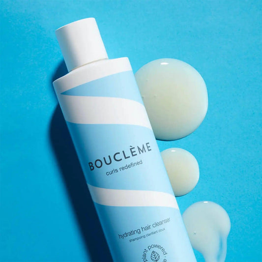 Boucleme Hydrating Hair Cleanser 300ml on blue background with product and cleanser drop, ideal for fine hair and waves.
