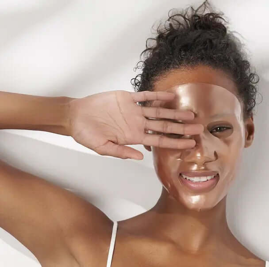 Woman applying 111SKIN Rose Gold Brightening Mask for radiant and youthful skin.