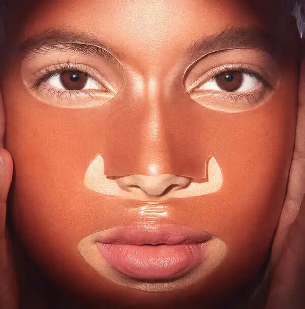 Model wearing 111SKIN Rose Gold Brightening Mask, showcasing radiant skin and luxurious hydrogel texture.