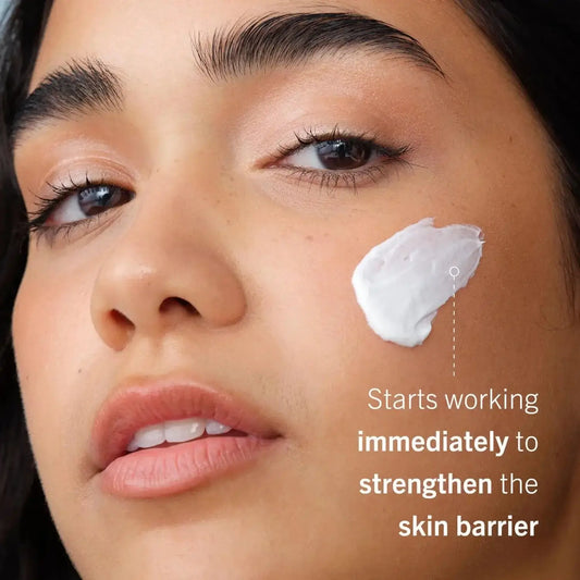 First Aid Beauty Ultra Repair Cream on model's face, nourishing and strengthening sensitive skin barrier.