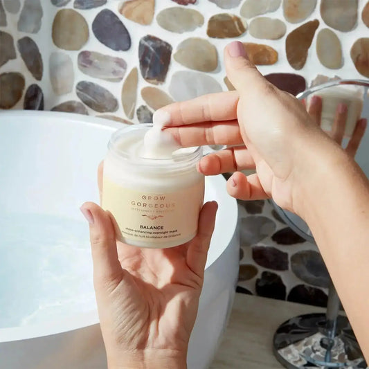 Person applying Grow Gorgeous Balance Hair and Scalp Mask in a serene bathroom setting.