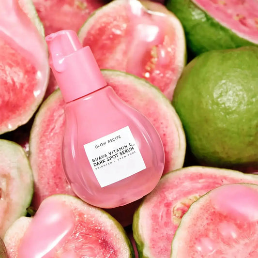 GLOW RECIPE Guava Vitamin C + Ferulic Dark Spot Serum on pink guava background, targeting dark spots and hyperpigmentation.