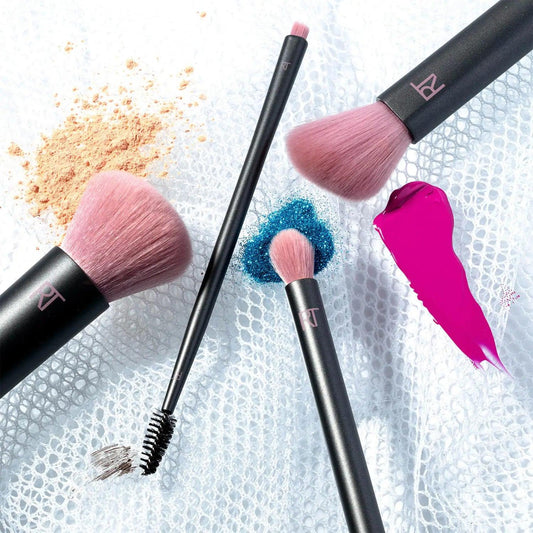 Real Techniques Easy as 123 Basics Kit featuring pink bristle brushes and makeup products on a mesh background.