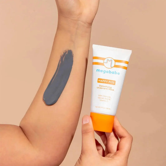 Megababe Happy Pits Detoxifying Underarm Mask 90ml applied on skin, showcasing its charcoal formula for detoxing.