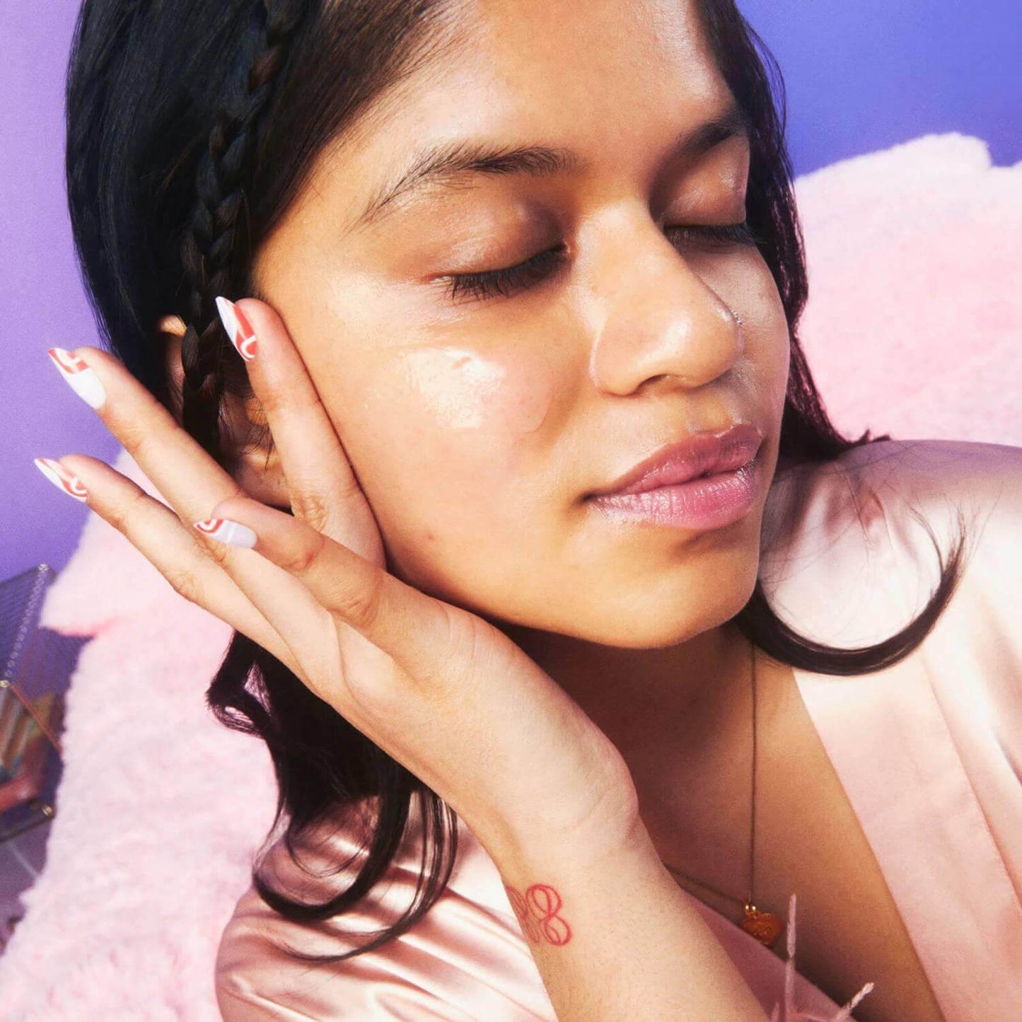 Woman enjoying a skincare treatment, showcasing a radiant complexion and relaxed pose, promoting glow and hydration.