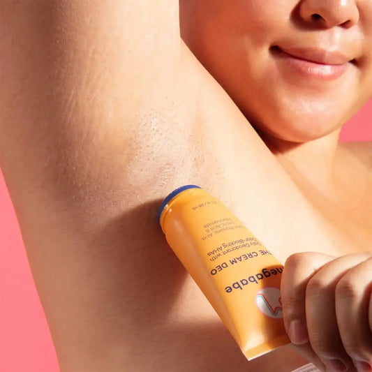 Megababe The Cream Deo applied to underarm, showcasing natural deodorant benefits and a smooth texture.