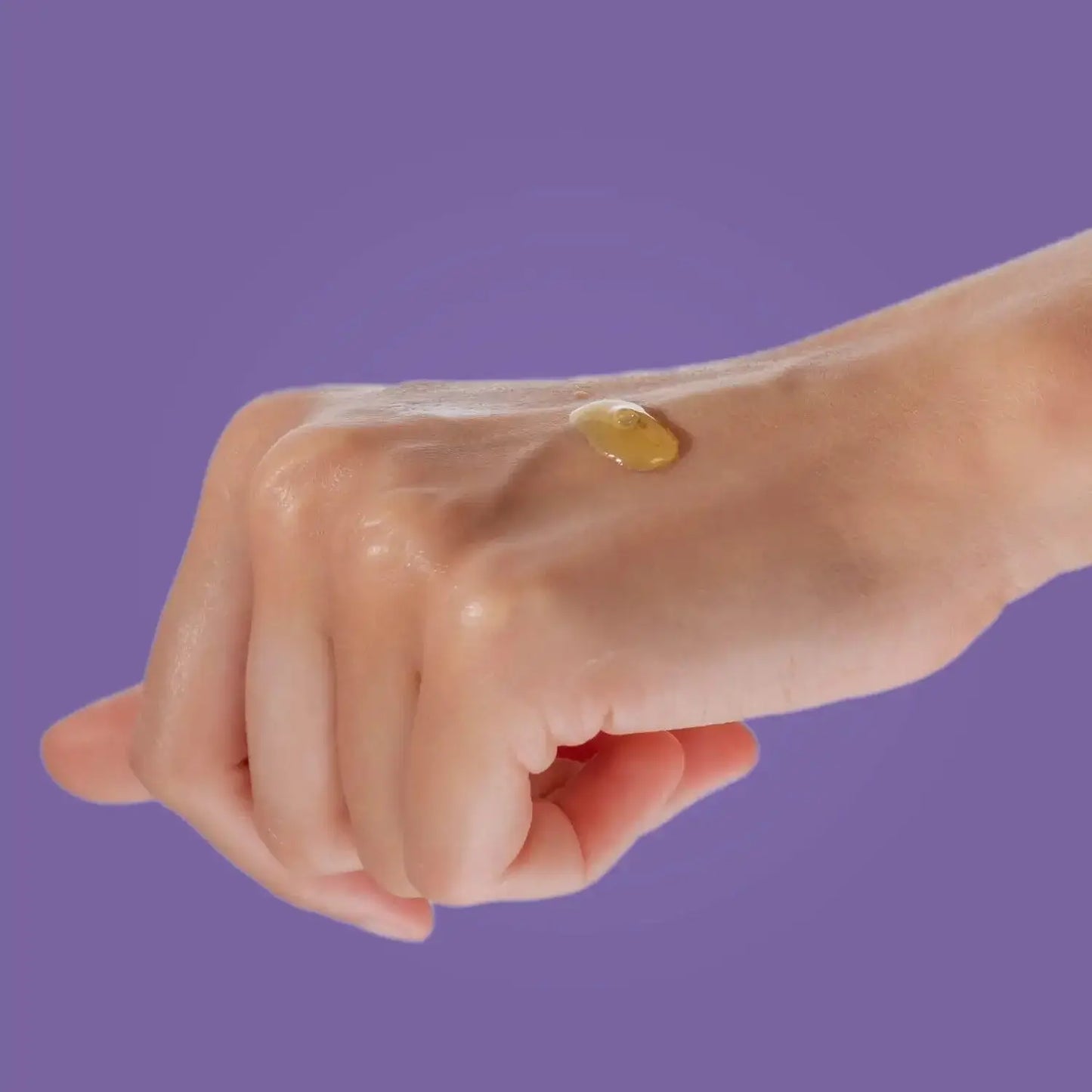Cultured Biomecare Resilience Facial Oil drop on hand for hydration and radiance.