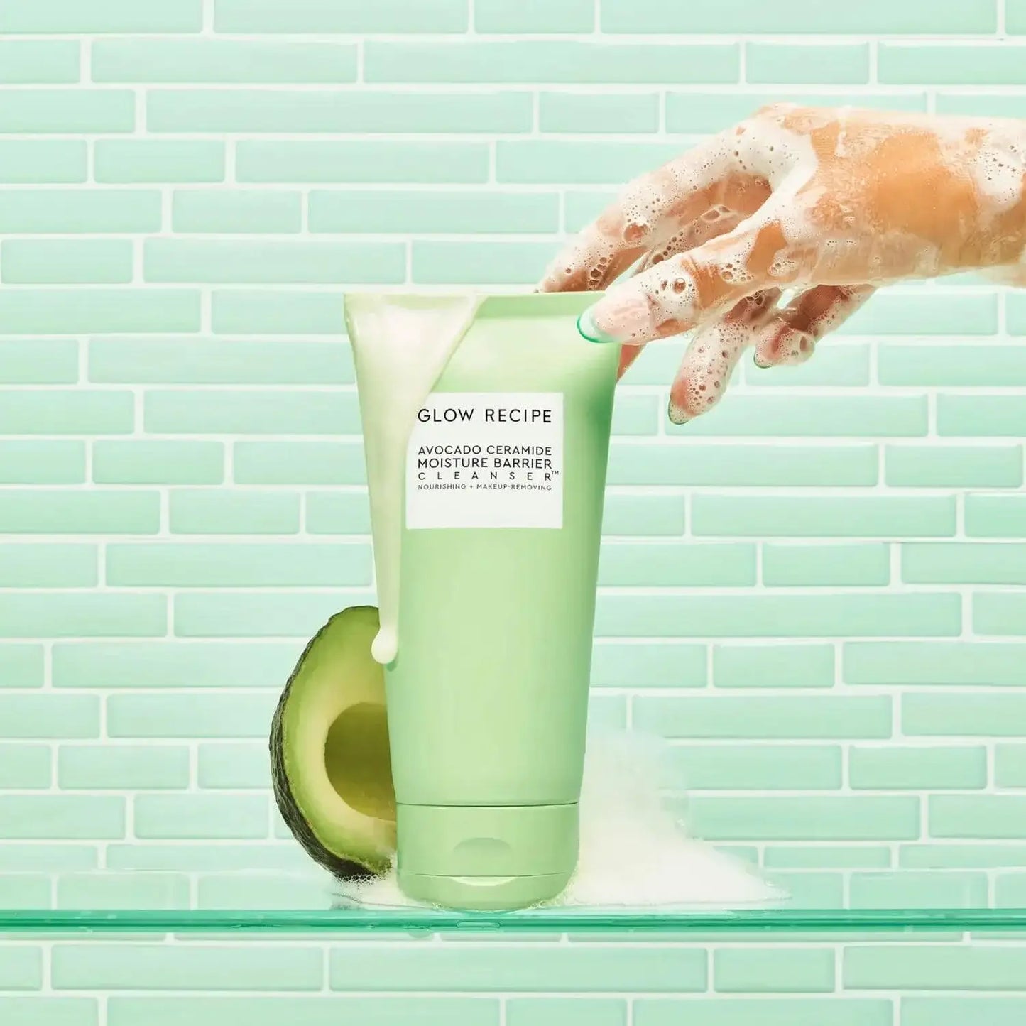 Glow Recipe Avocado Ceramide Cleanser 150ml with creamy foam and avocado on a mint green background.