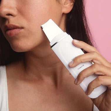 Close-up of a person using the LUX SKIN® Sonic Exfoliating Wand on their face for skincare.