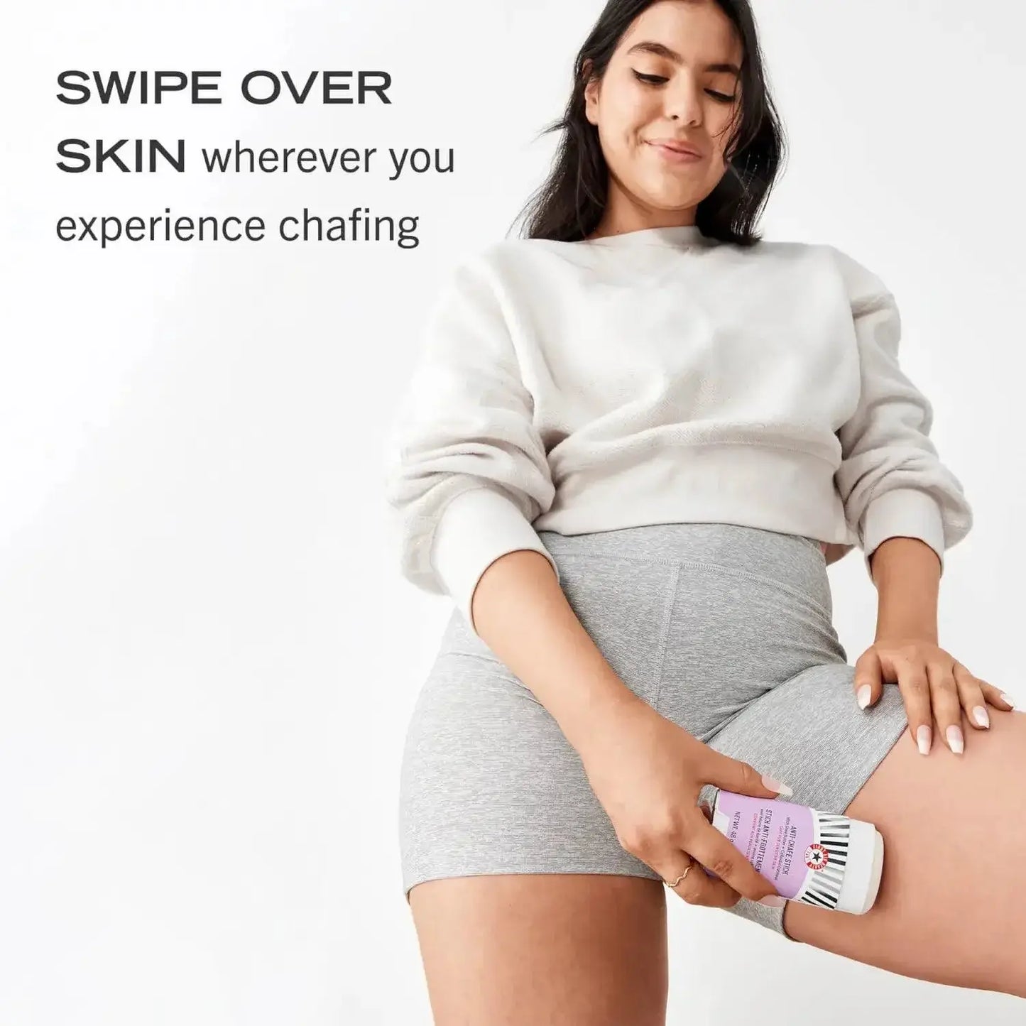 Model demonstrating First Aid Beauty Anti-Chafe Stick on skin to prevent friction and chafing.