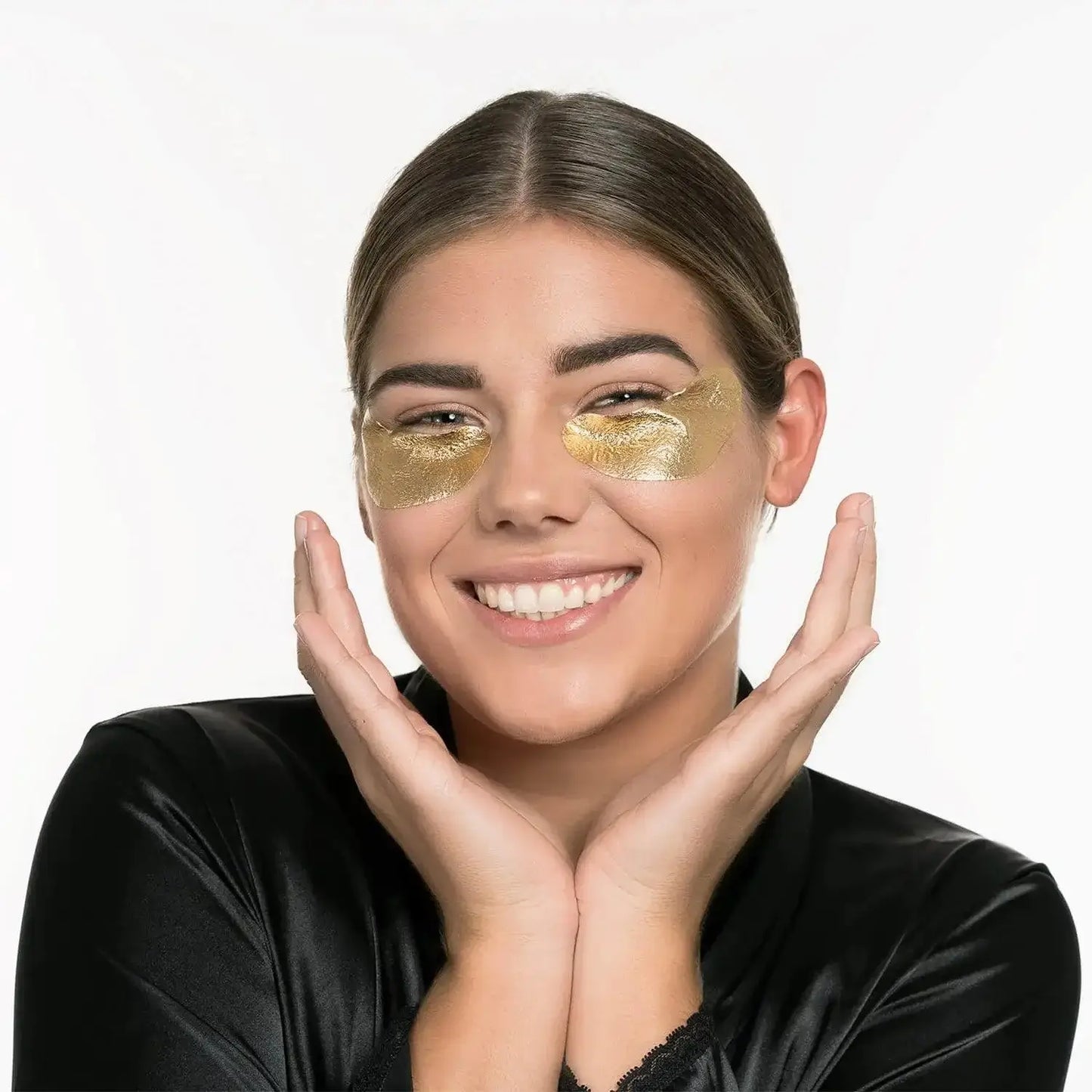 Smiling woman wearing STARSKIN The Gold Eye Mask, showcasing its rejuvenating effects on under-eyes.