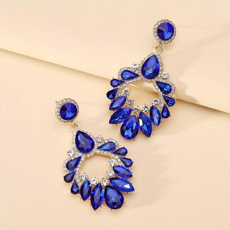 Elegant luxury style earrings with blue gemstones and sparkling accents, perfect for special occasions.