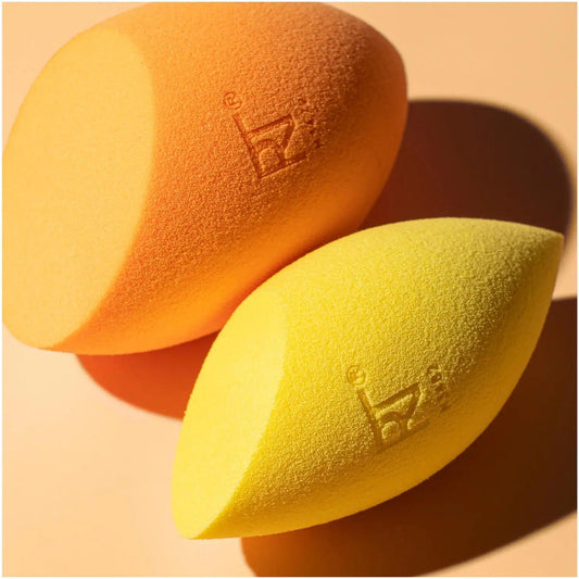 Real Techniques Miracle Complexion Sponge and Concealer Sponge Duo in orange and yellow for flawless makeup application.