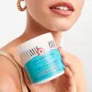 Model holding First Aid Beauty Facial Radiance Pads, showcasing radiance-boosting skincare for brighter complexion.