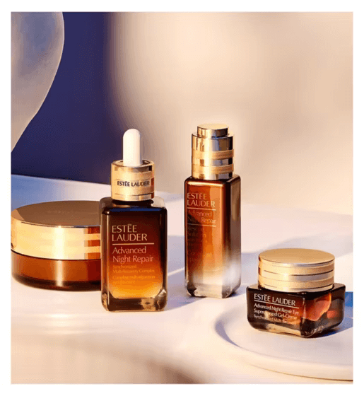 Esteé Lauder Advanced Night Repair Serum and skincare products on a countertop for nighttime skincare routine.