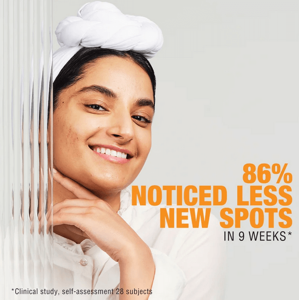 Smiling woman with clear skin, showcasing NEUTROGENA® results of 86% noticing fewer spots in 9 weeks.