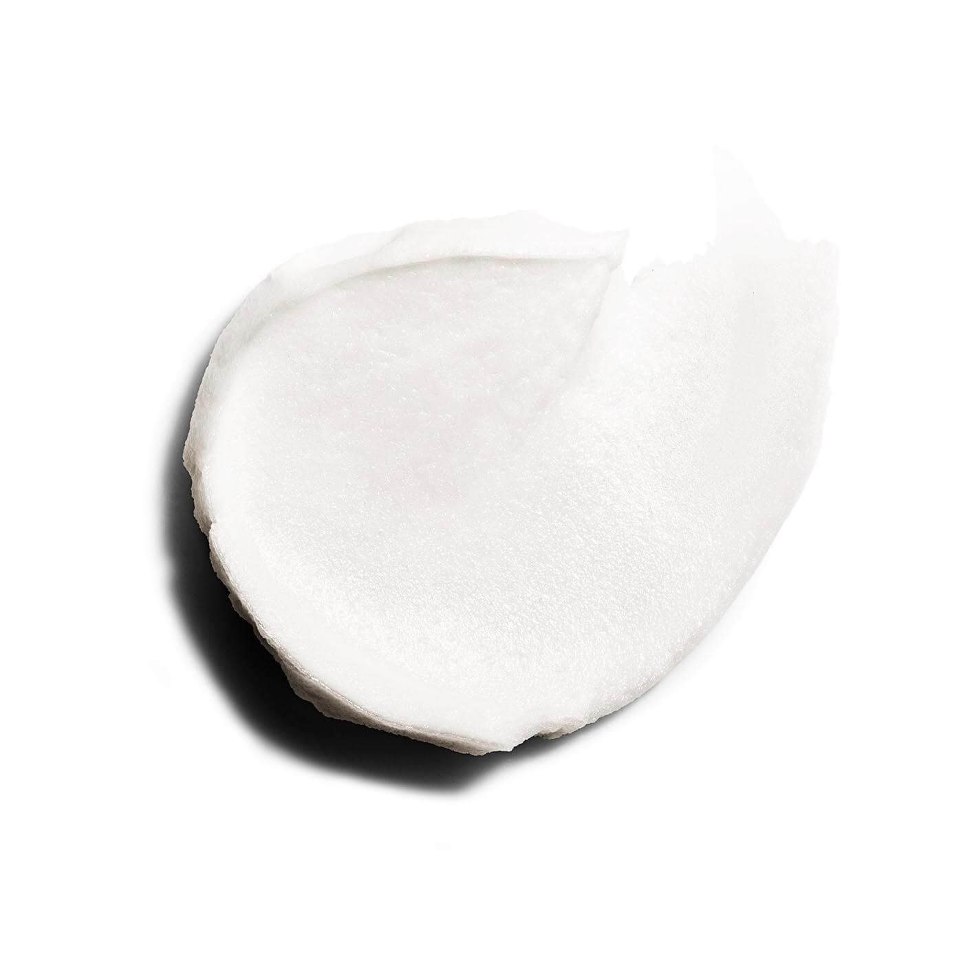 A close-up of a smooth, white, foamy texture from Clarins Hydrating Gentle Foaming Cleanser.