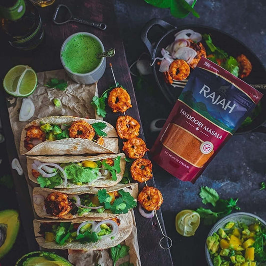 Delicious tacos topped with shrimp and avocado, featuring Rajah Tandoori Masala packaging for authentic Indian flavor.