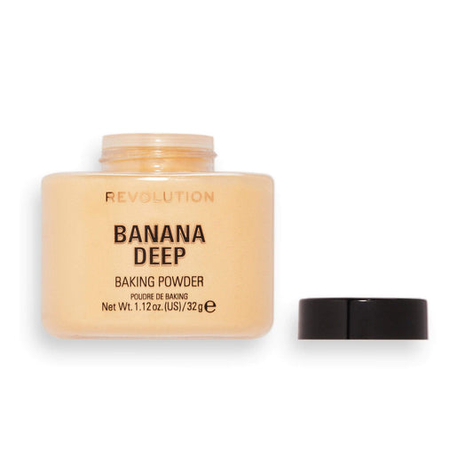 Makeup Revolution Loose Baking Powder Banana Deep in jar; ideal for brightening skin and setting makeup.