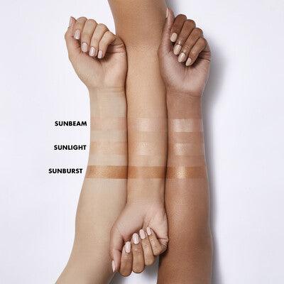 Swatches of e.l.f Suntouchable! Whoa Glow SPF 30 in Sunbeam, Sunlight, and Sunburst on different skin tones.