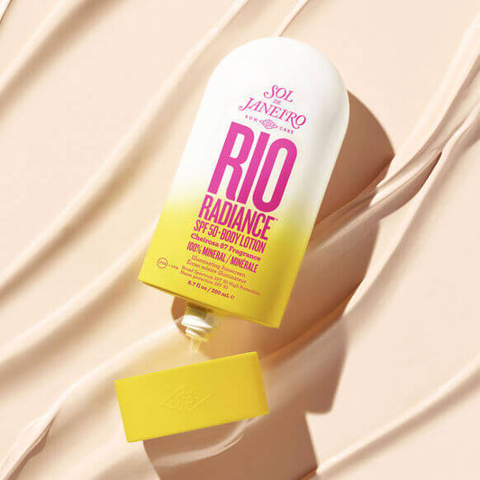 Sol de Janeiro Rio Radiance Body Lotion SPF 50 200ml on a sandy background, showcasing vibrant packaging and sun protection benefits.