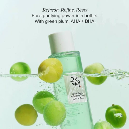 Green plum toner bottle with green plums and water droplets on a light green background