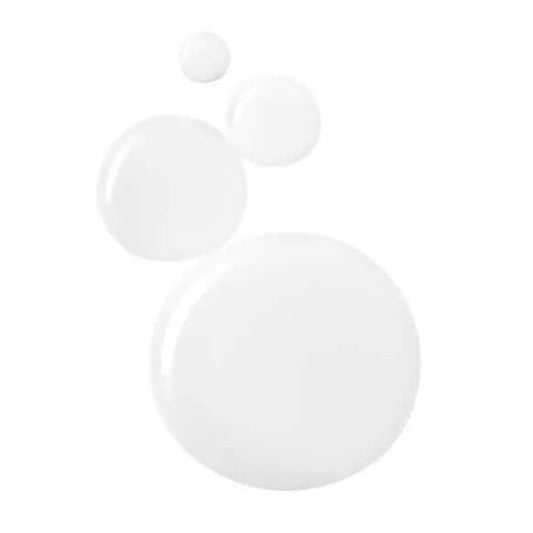 White cream drops on a clean surface, showcasing texture and consistency for skincare products.