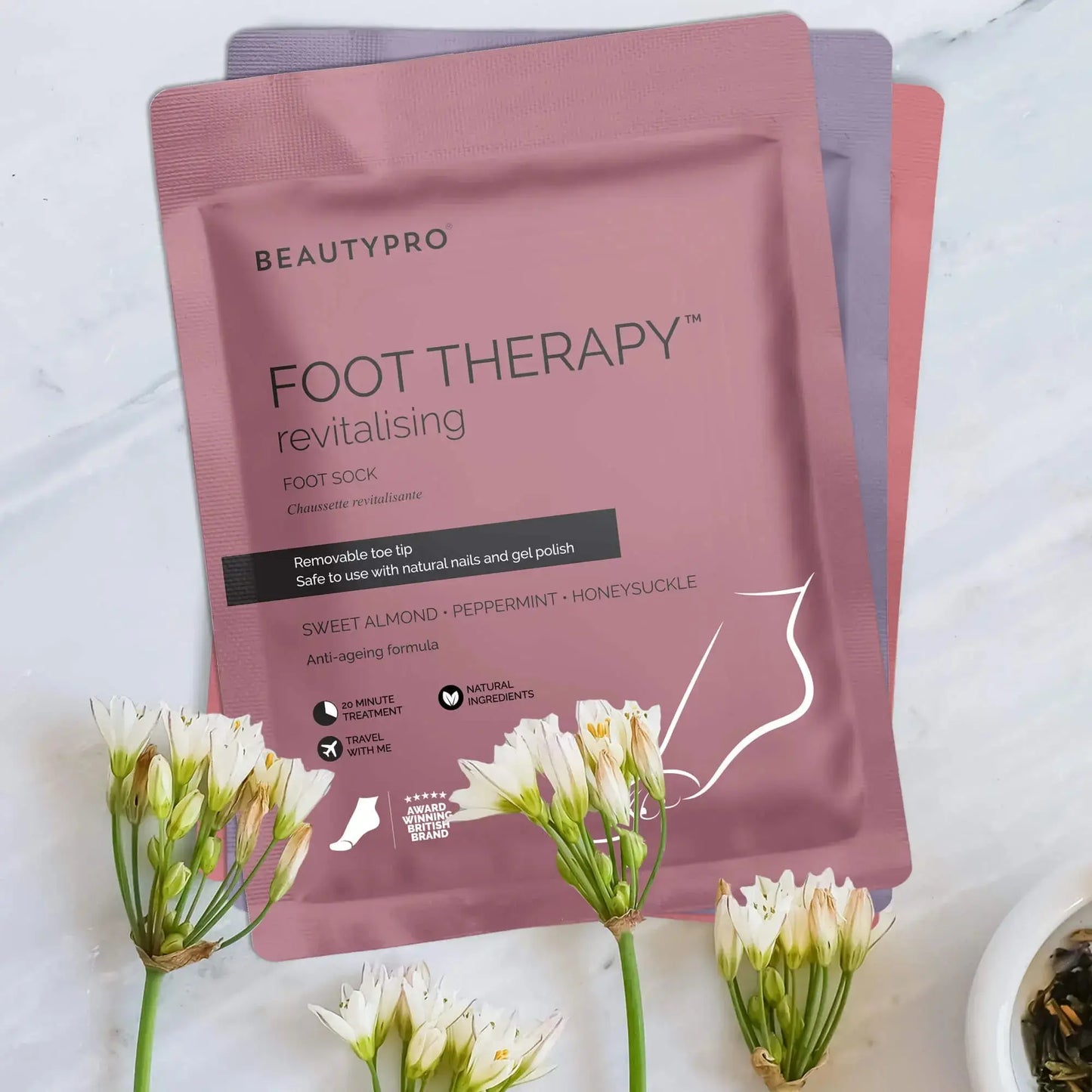 BeautyPro Foot Therapy revitalising foot sock packaging with sweet almond, peppermint, and honeysuckle extracts.