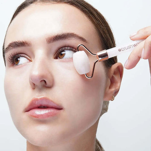 Model using Brushworks Brazilian Rose Quartz Stone Roller for facial massage and skincare absorption