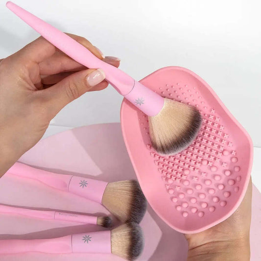 Brushworks Brush Cleaner Palette with pink brush, showcasing ergonomic design and textured surfaces for cleaning.