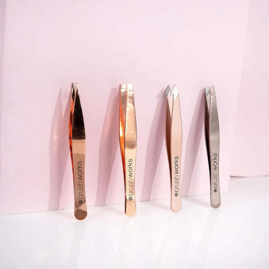 Brushworks HD Combination Tweezer Set in gold, rose gold, and silver displayed for eyebrow grooming.