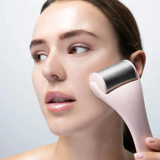 Woman using Brushworks Ice Roller on her face for a refreshed complexion and reduced puffiness.