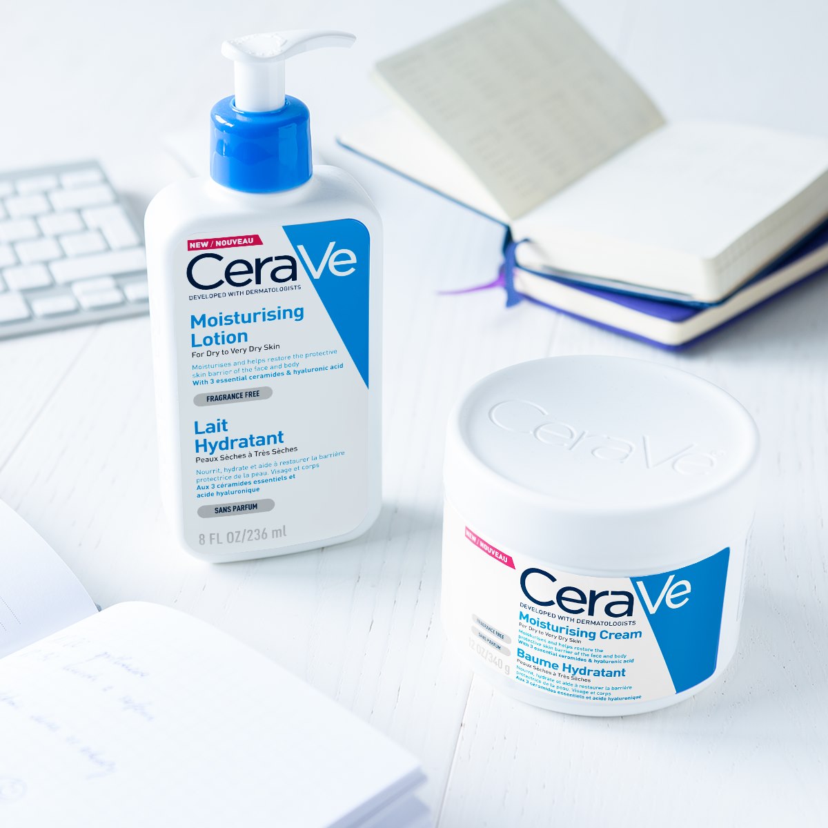 CeraVe moisturizing lotion and cream on a desk with a keyboard and notebook in the background
