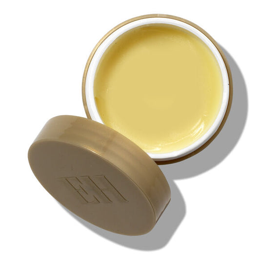 Open jar of Emma Hardie Moringa Cleansing Balm yellow cream with beige lid on a white background