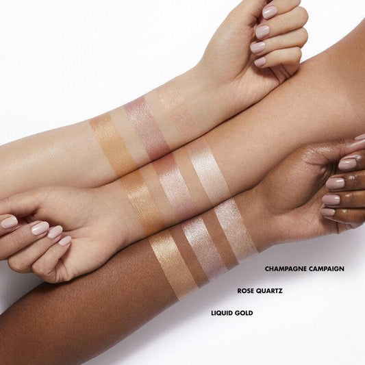Swatches of e.l.f Halo Glow Highlight Beauty Wand in Champagne Campaign, Rose Quartz, and Liquid Gold.
