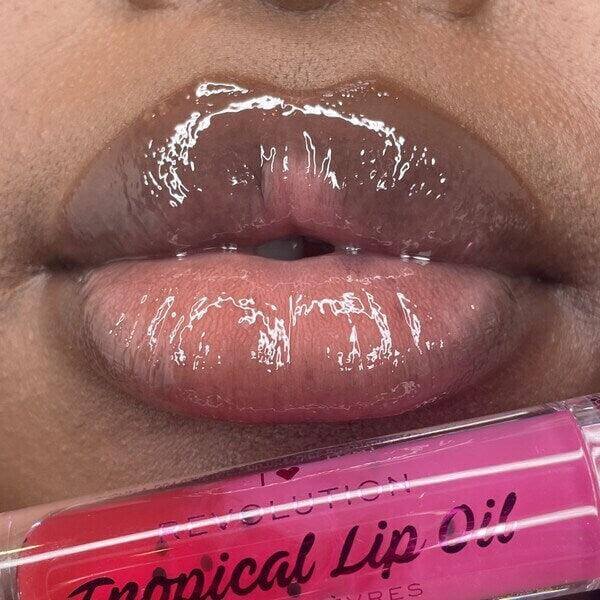 Close-up of glossy lips wearing I Heart Revolution Tasty Tropical Lip Oil in Pomegranate, showcasing shine and hydration.