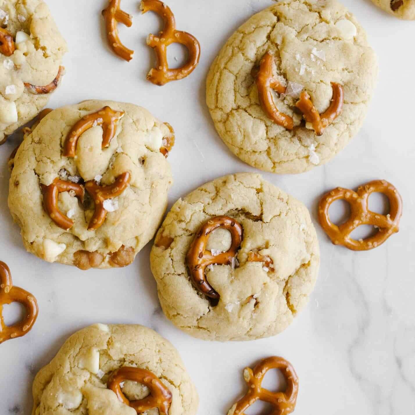 ASDA Extra Special Cookies topped with pretzels on a marble surface, showcasing luxury snack indulgence.