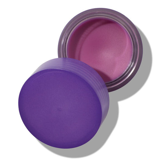 Purple container with pink cream inside on a white background