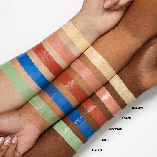 Swatches of e.l.f Camo Color Corrector in five shades: green, blue, orange, peach, and yellow on diverse skin tones.