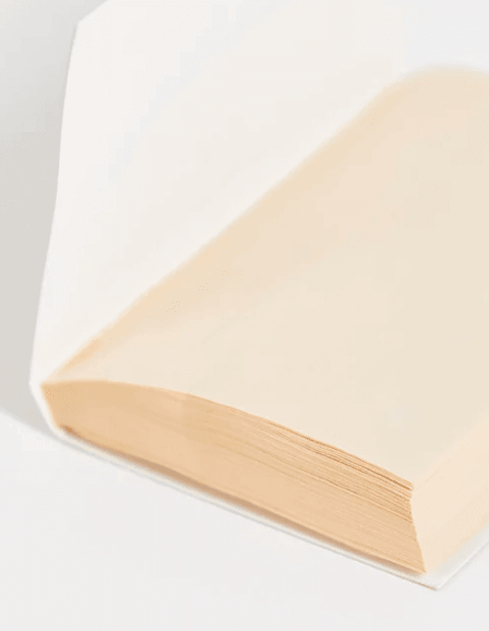 Close-up of the edge of a book with cream-colored pages, showcasing a smooth and elegant design.