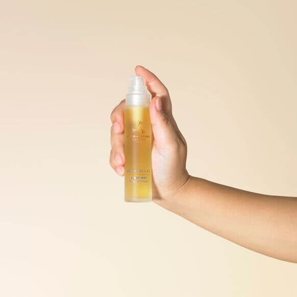 Aromatherapy Associates Deep Relax Sleep Mist 50ml in hand, showcasing a calming essential oil blend.