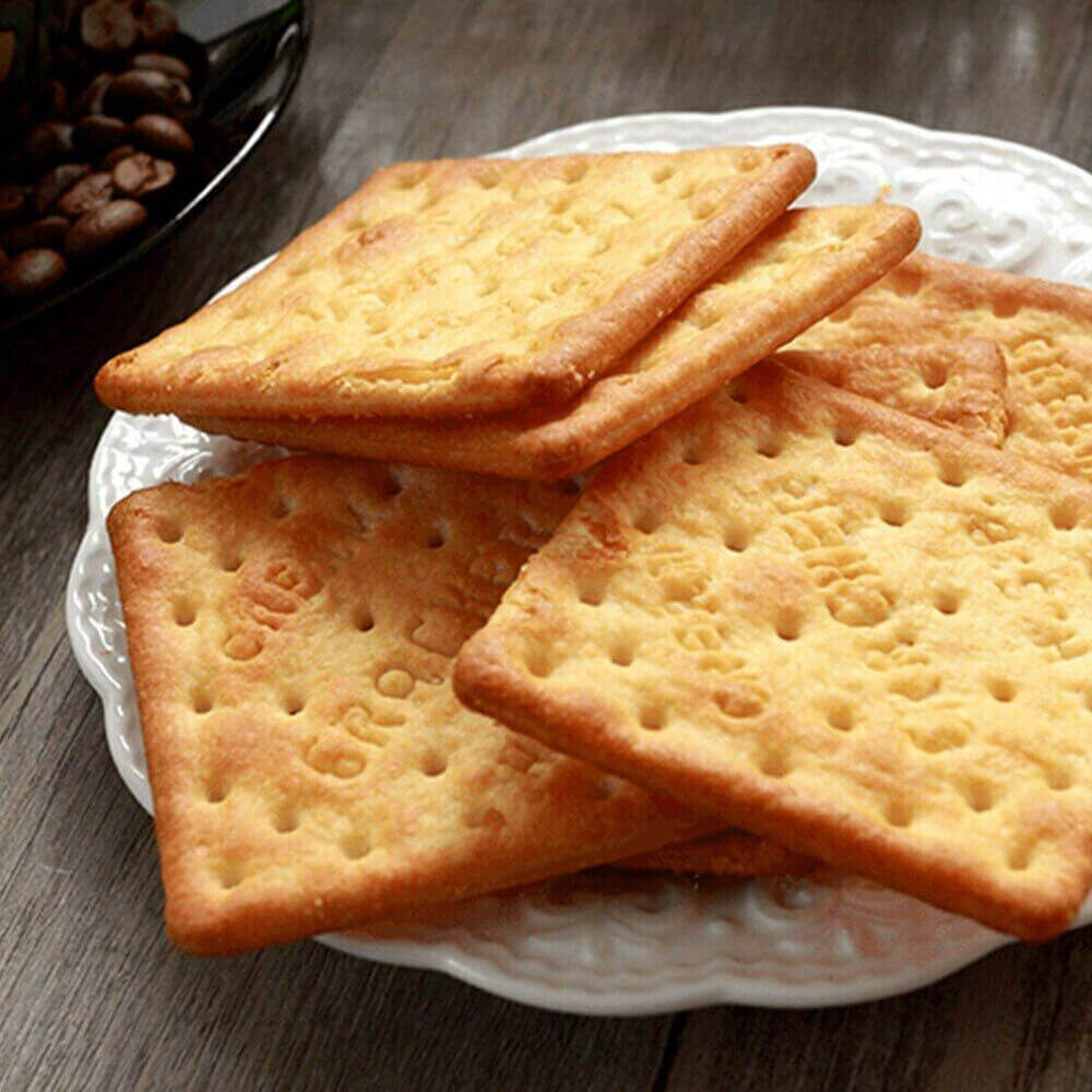 Delicious ASDA Cream Crackers on a decorative plate, showcasing their crispy texture and golden color.