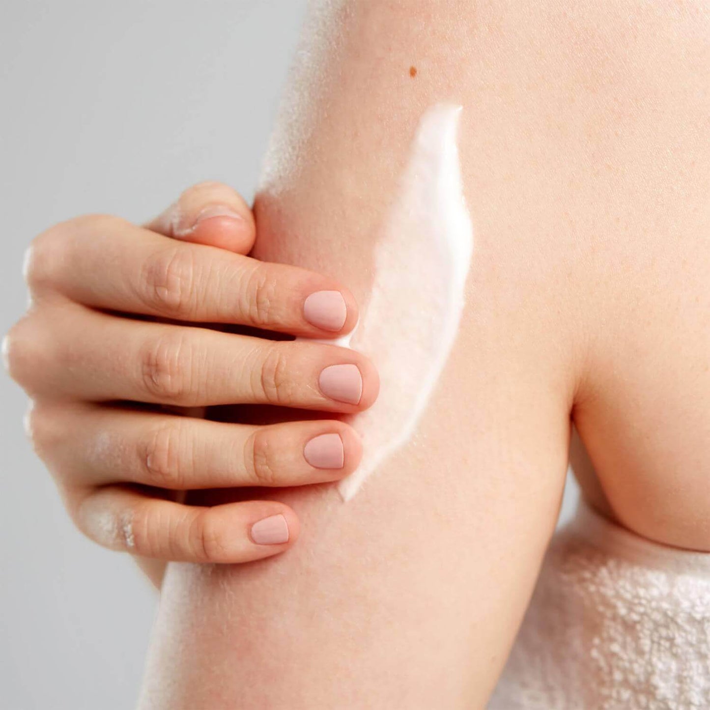 Applying AMELIORATE Transforming Body Lotion on skin for smooth, hydrated, and exfoliated texture.