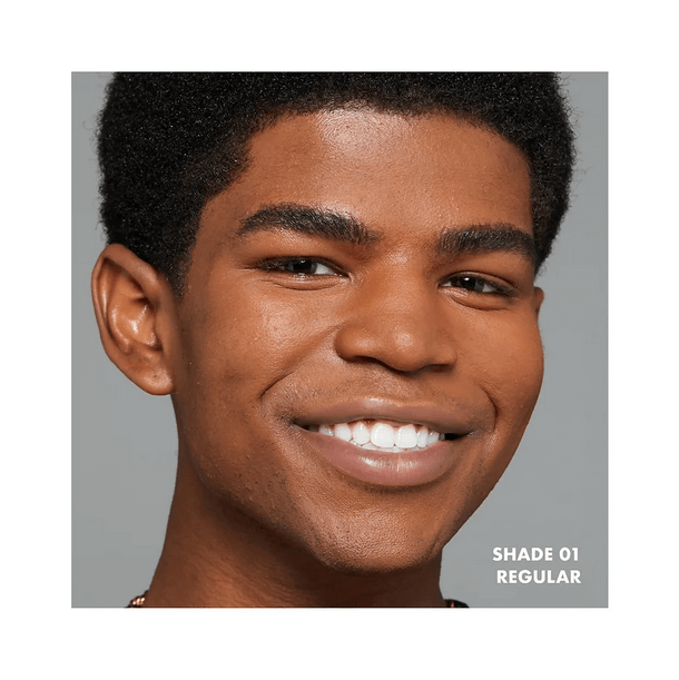 Close-up of a smiling person showcasing NYX Professional Makeup Foundation in Shade 01 Regular.