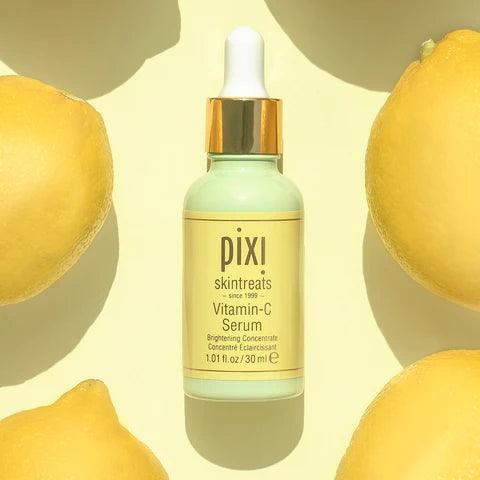 Pixi Vitamin-C Serum 30 ml bottle surrounded by fresh lemons, promoting radiant skin and improved complexion.