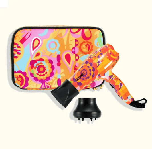 Amika Mighty Mini Dryer in vibrant design with matching case, perfect for portable hair styling on the go.