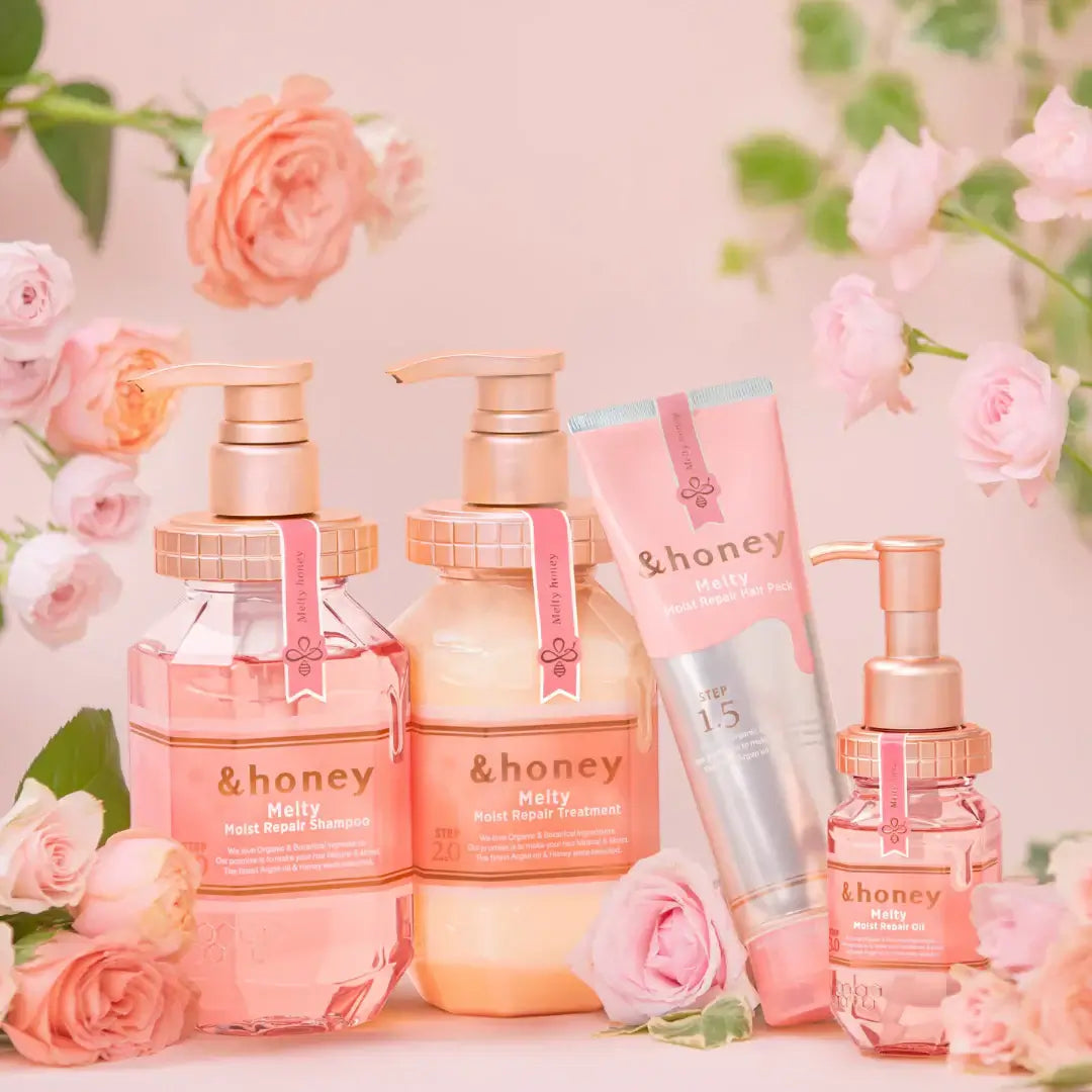 &honey Melty Moist Repair hair products display with pink roses, including shampoo, treatment, and hair mask.
